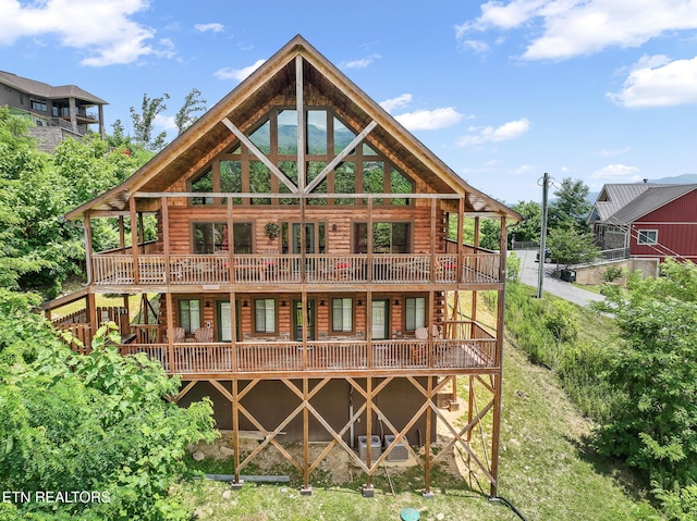 rear view of house with a wooden deck