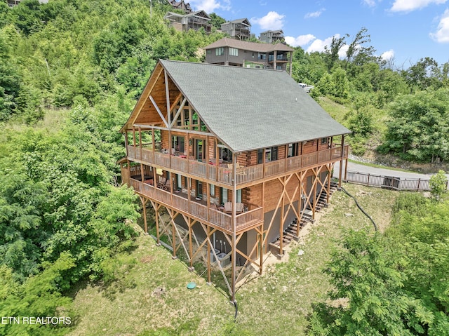 rear view of property featuring a wooden deck