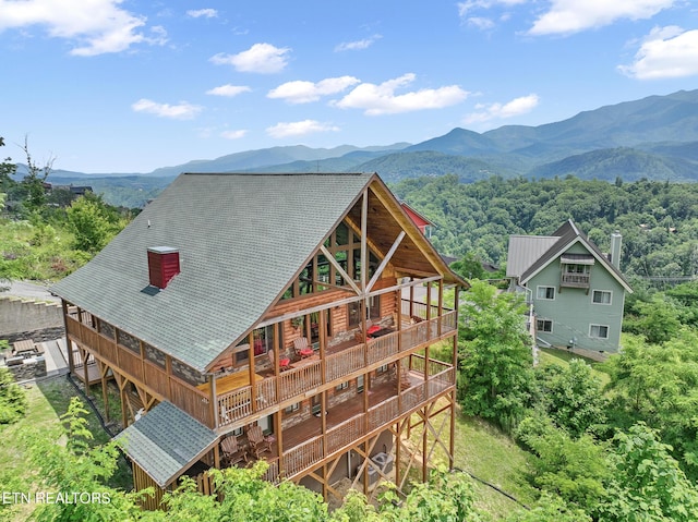 rear view of property with a mountain view