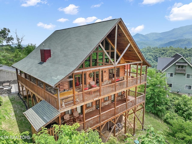 back of house with a deck with mountain view