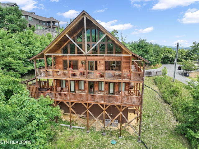 rear view of house with a wooden deck