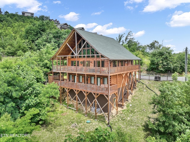 rear view of house with a wooden deck