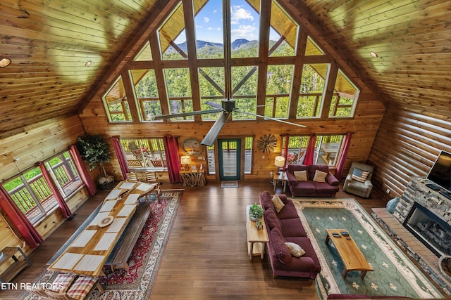 unfurnished living room with beam ceiling, high vaulted ceiling, and wood ceiling