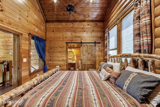 unfurnished bedroom featuring wood walls, wooden ceiling, lofted ceiling, and a barn door