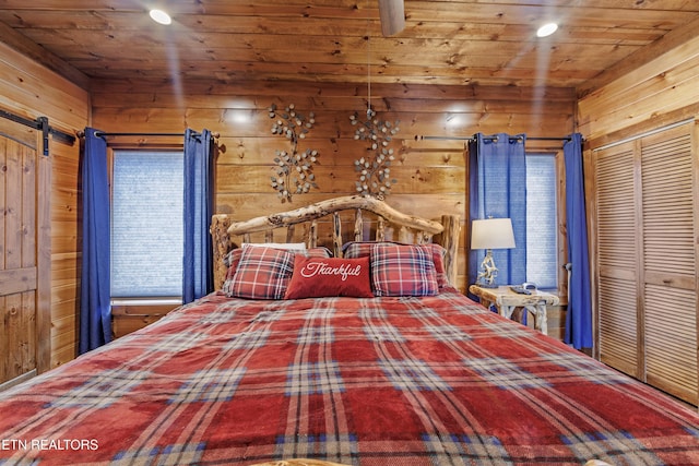 unfurnished bedroom featuring wooden ceiling, a closet, and wooden walls