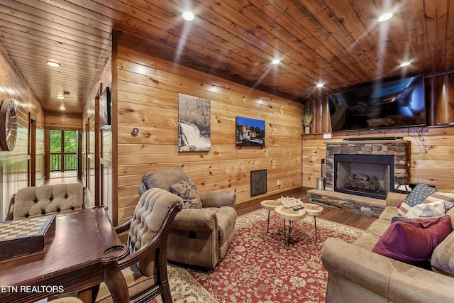 living room with a fireplace, wood walls, hardwood / wood-style floors, and wood ceiling