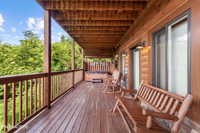 wooden deck with a hot tub