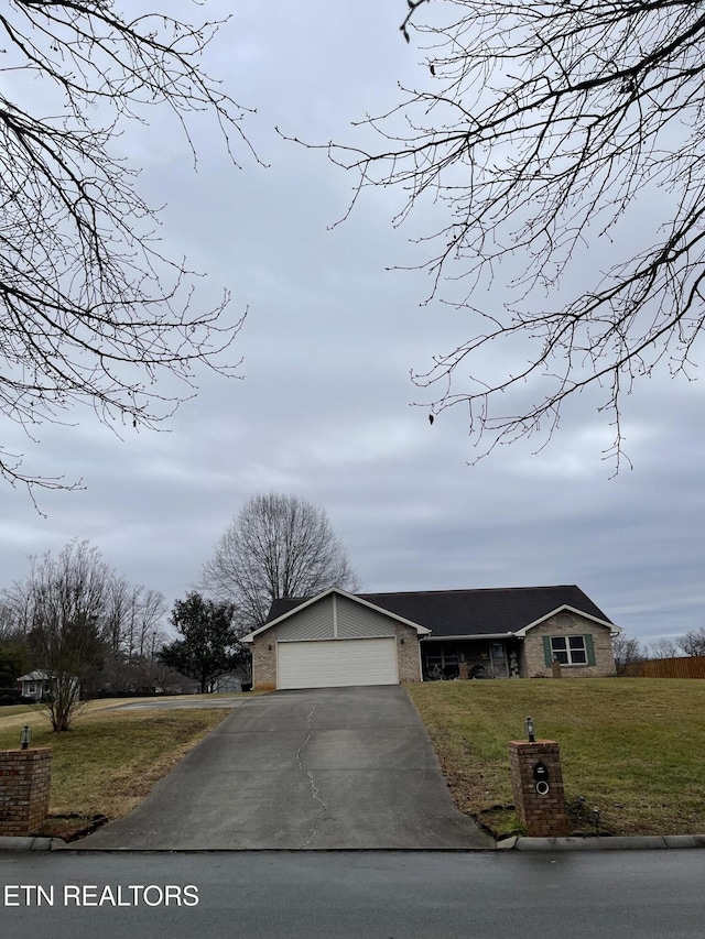 view of front of home featuring a garage and a front lawn