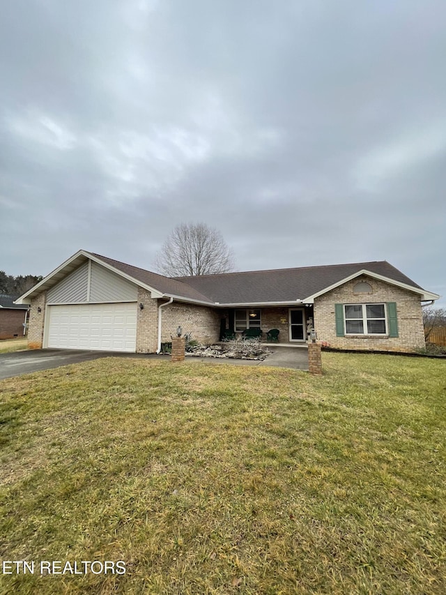 ranch-style home with a garage and a front yard