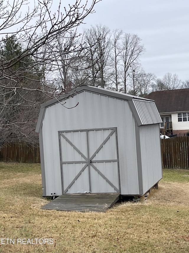 view of outbuilding with a lawn