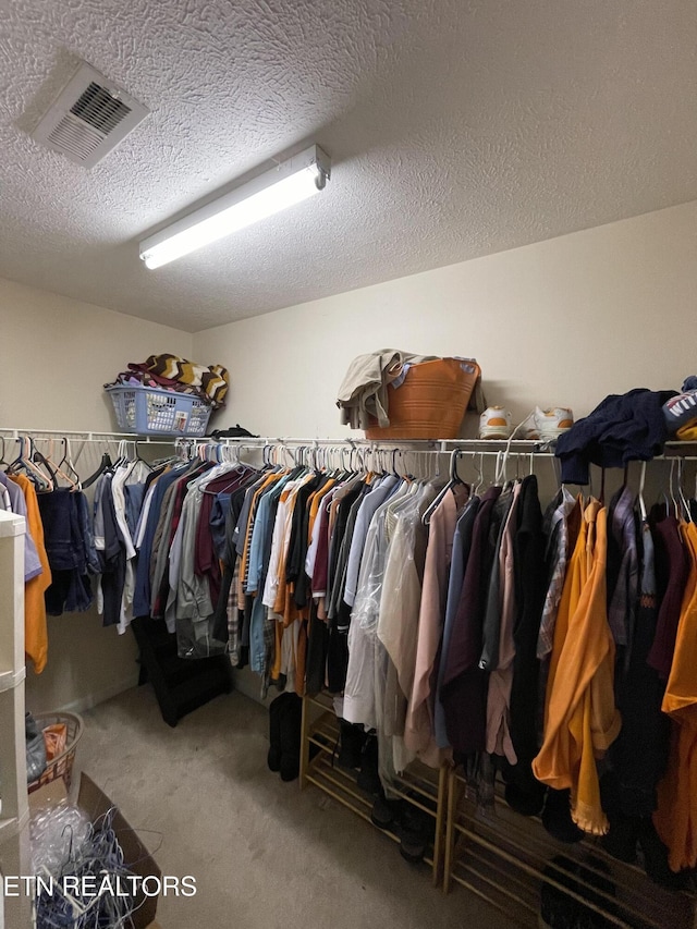 walk in closet featuring carpet