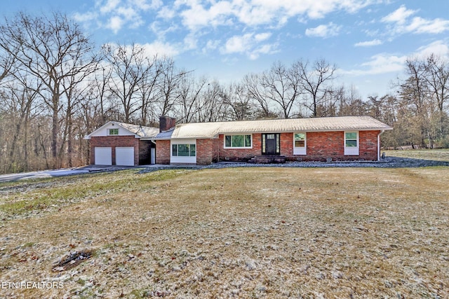 ranch-style house with a garage and a front yard