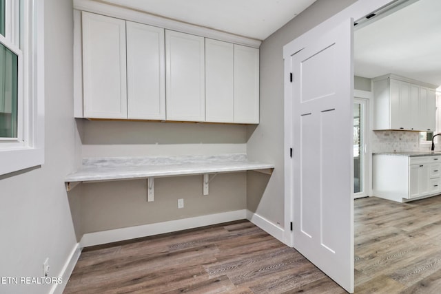 washroom with light hardwood / wood-style floors, sink, and a barn door