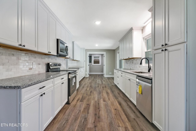 kitchen featuring sink, stainless steel appliances, and white cabinetry