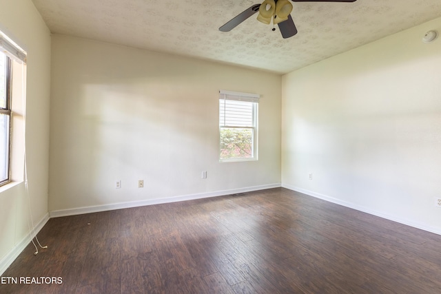 spare room with dark hardwood / wood-style flooring, ceiling fan, and a textured ceiling