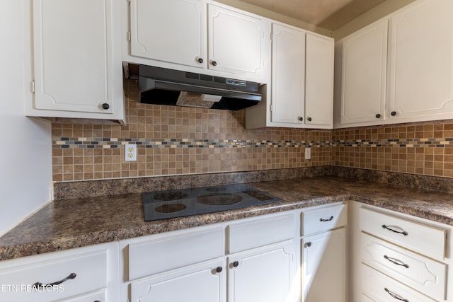 kitchen with tasteful backsplash, white cabinetry, and black electric cooktop