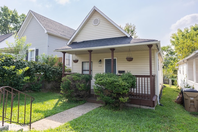 view of front of house with a porch and a front lawn