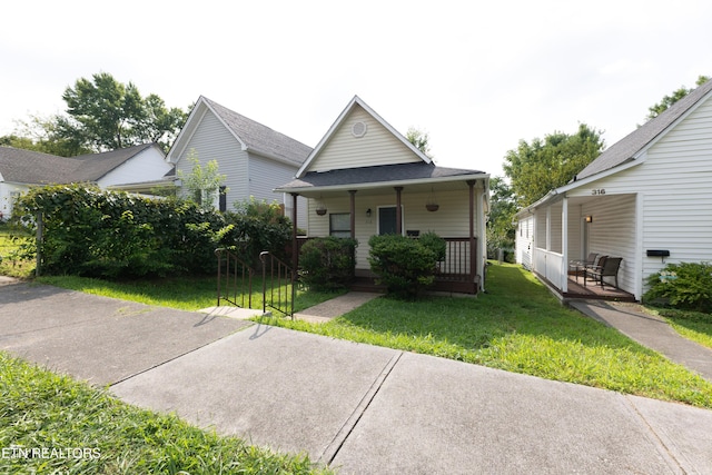 view of front of property featuring covered porch and a front yard