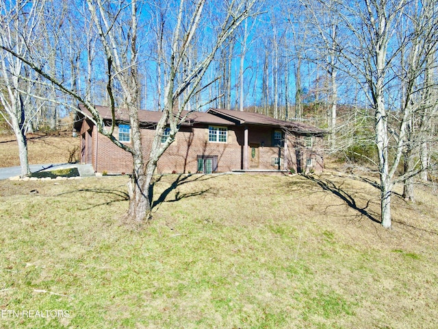 rear view of property featuring a yard