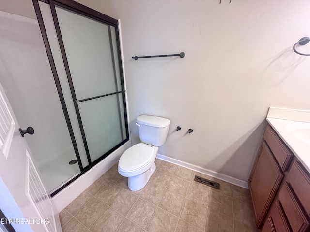 bathroom featuring walk in shower, vanity, and toilet