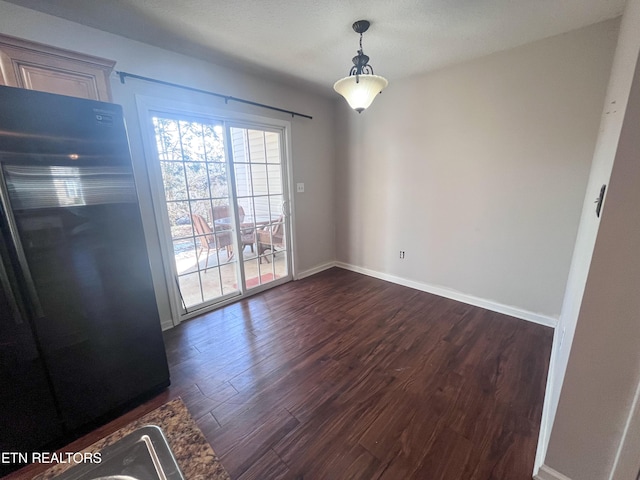 unfurnished dining area featuring dark hardwood / wood-style floors