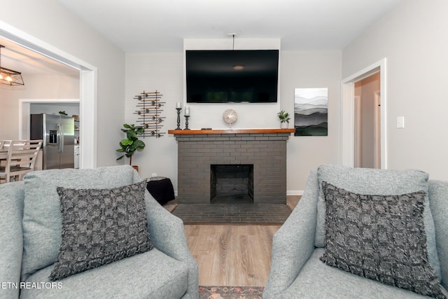 living room with hardwood / wood-style flooring and a fireplace