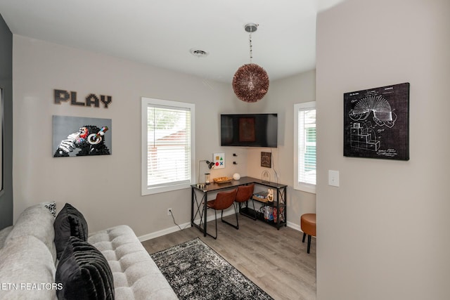 office space with a healthy amount of sunlight and light hardwood / wood-style floors