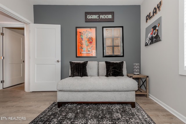 living area with hardwood / wood-style flooring