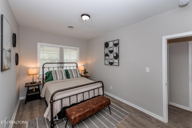 bedroom with dark hardwood / wood-style flooring