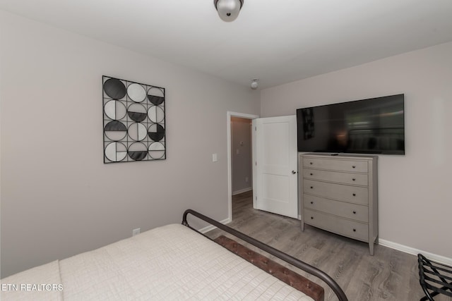 bedroom with hardwood / wood-style flooring