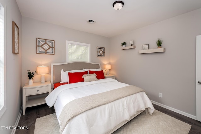 bedroom with dark wood-type flooring