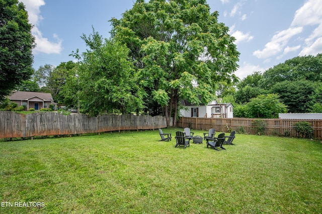 view of yard with a fire pit