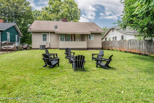 back of house with a lawn and central air condition unit