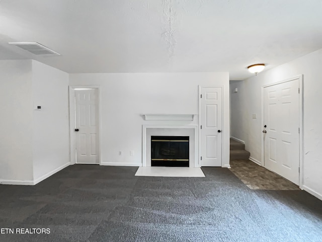 unfurnished living room featuring dark colored carpet