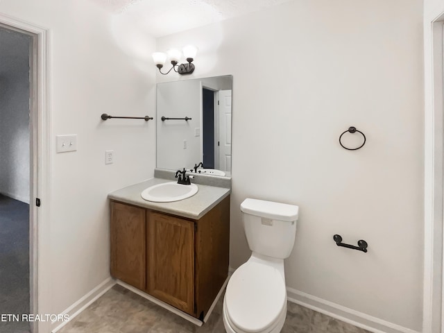 bathroom featuring toilet and vanity