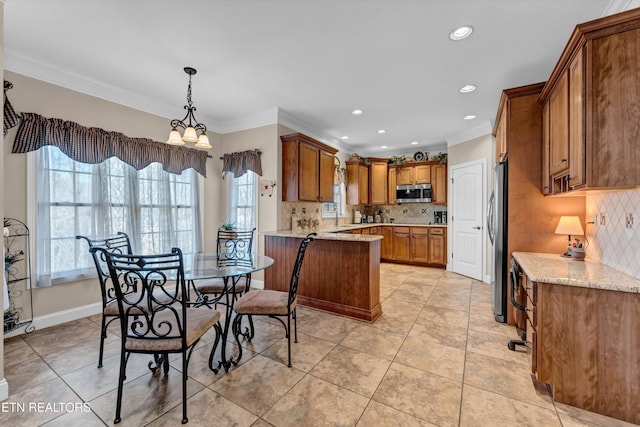 dining room with a notable chandelier, ornamental molding, sink, and light tile patterned flooring