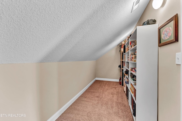 interior space with lofted ceiling and light colored carpet