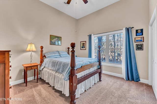 bedroom with ceiling fan, a closet, and light carpet