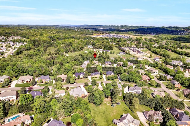 bird's eye view with a wooded view and a residential view