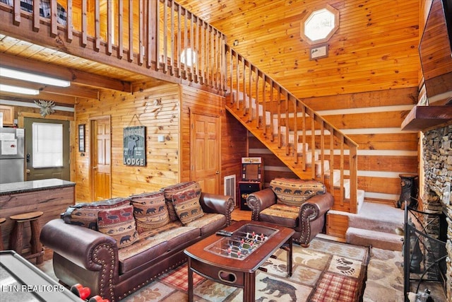 living room featuring wood ceiling and wood walls