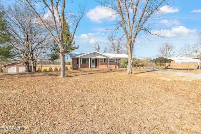 ranch-style home featuring a carport and covered porch