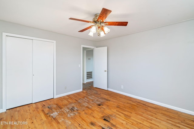 unfurnished bedroom with a closet, ceiling fan, and light hardwood / wood-style flooring