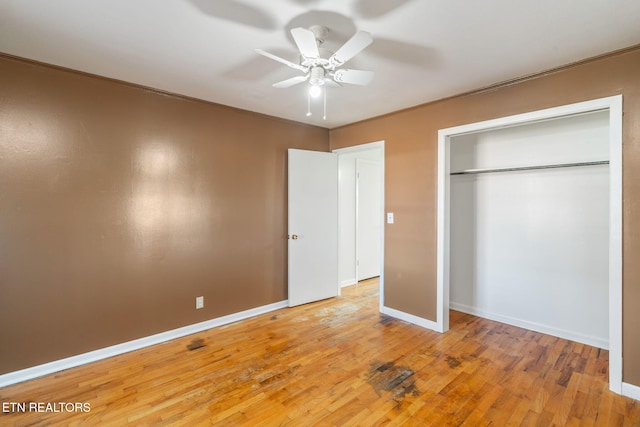 unfurnished bedroom with hardwood / wood-style flooring, ornamental molding, a closet, and ceiling fan