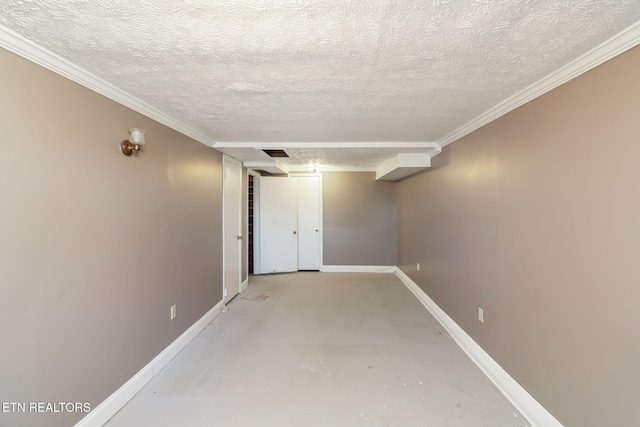 basement featuring ornamental molding and a textured ceiling