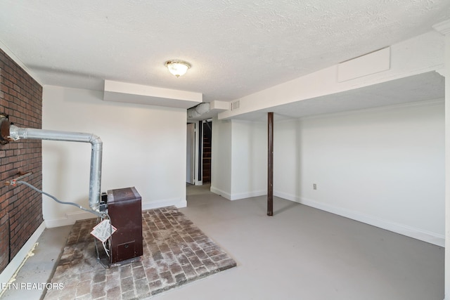 basement featuring brick wall and a textured ceiling