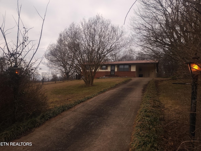 view of front facade with a carport and a front yard