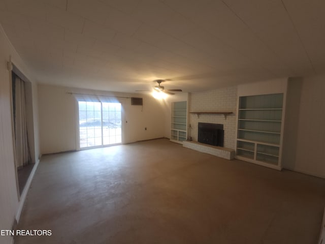 unfurnished living room featuring ceiling fan, built in features, concrete flooring, and a brick fireplace