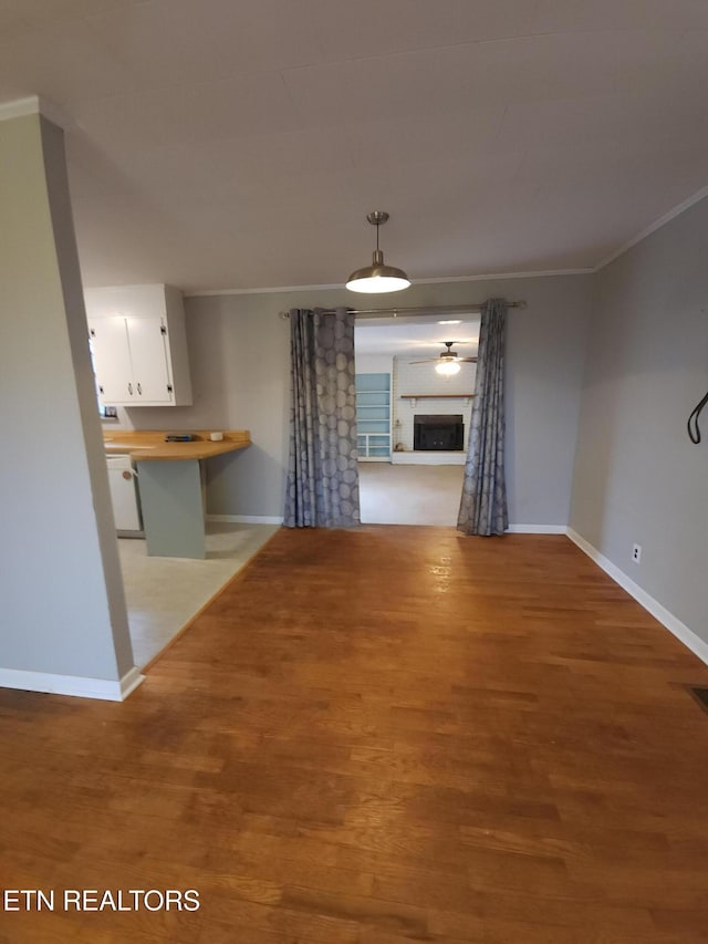 interior space with ornamental molding and light hardwood / wood-style flooring