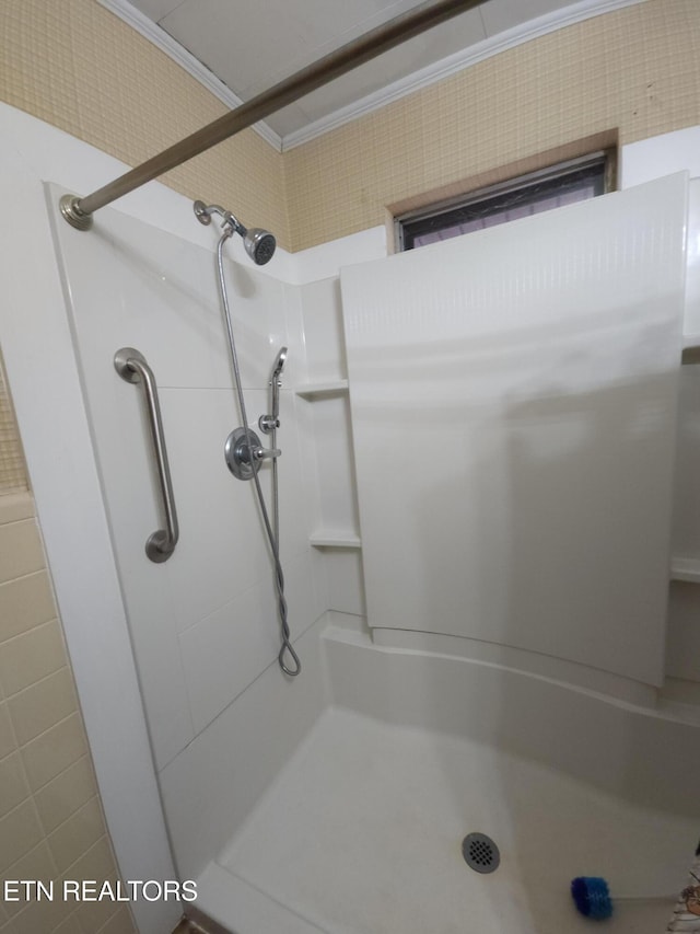 bathroom featuring crown molding and walk in shower