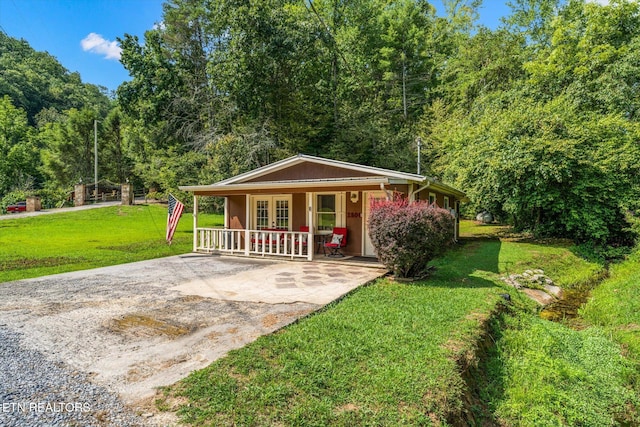 exterior space featuring french doors and a front lawn